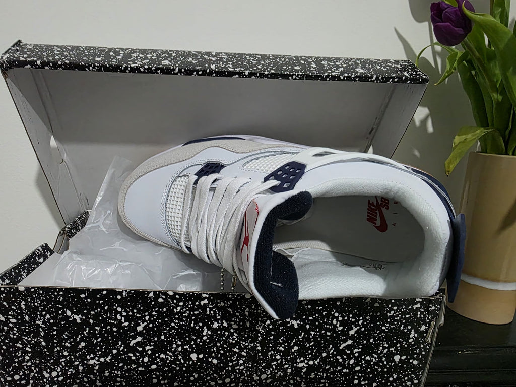 Nike Air Jordan 4 style trainers inside a speckled box, showcasing premium authentic design and comfort.